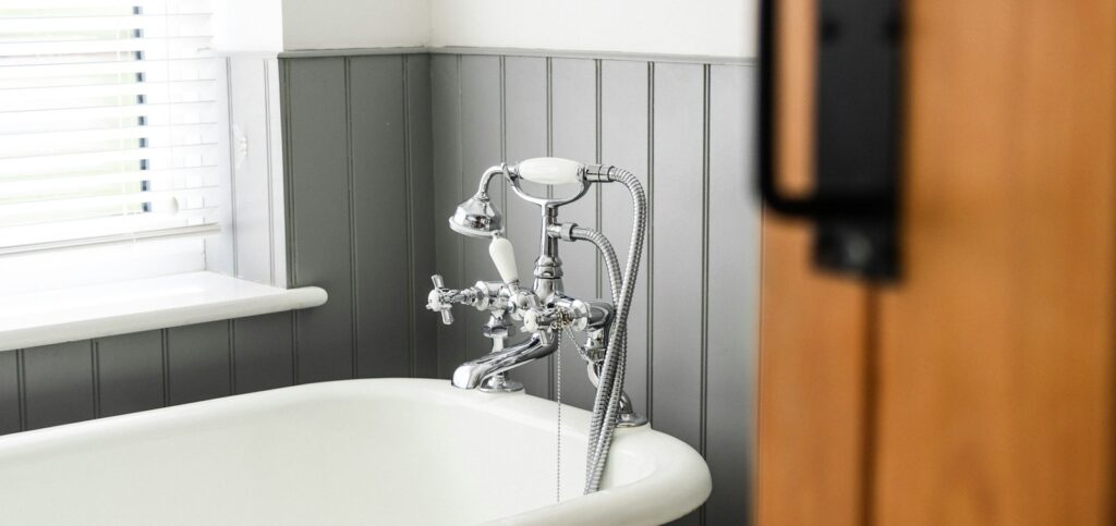 a bathroom with a claw foot tub and a wooden door