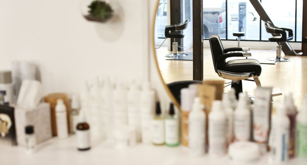 black and silver office rolling chair beside mirror