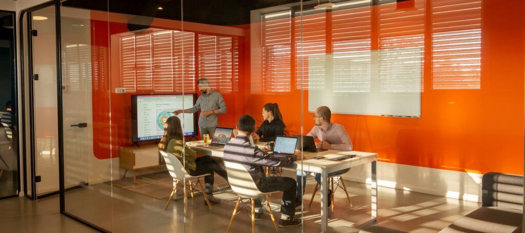 a group of people sitting around a table in a room