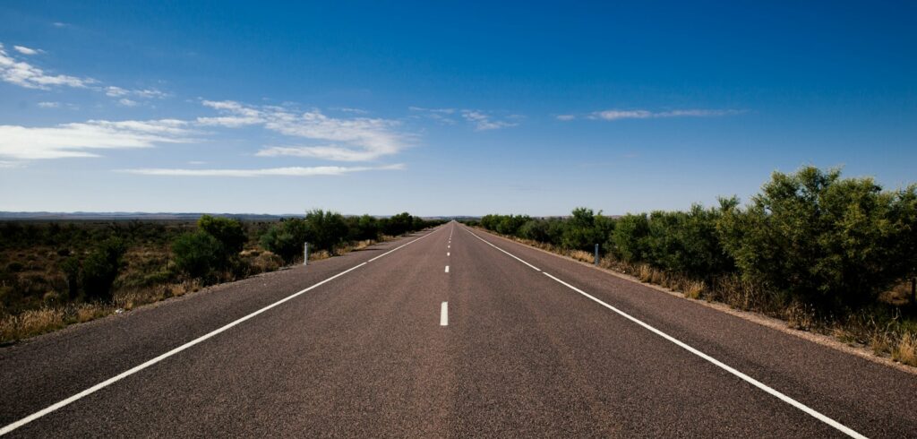 gray asphalt road under blue sky during daytime