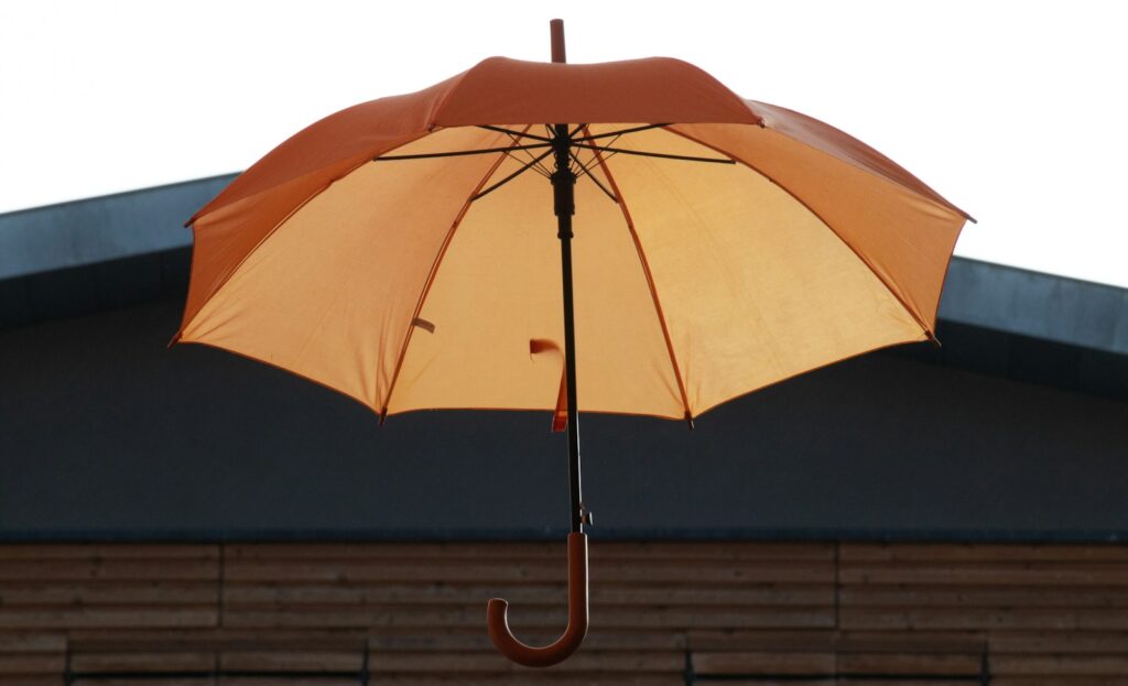 an orange umbrella on a roof